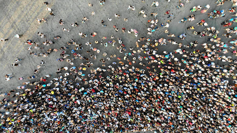 An aerial view of hundreds of people.